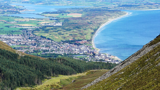 Newcastle from The Mourne Mountains. Newcastle is seaside resort town in County Down, Northern Ireland